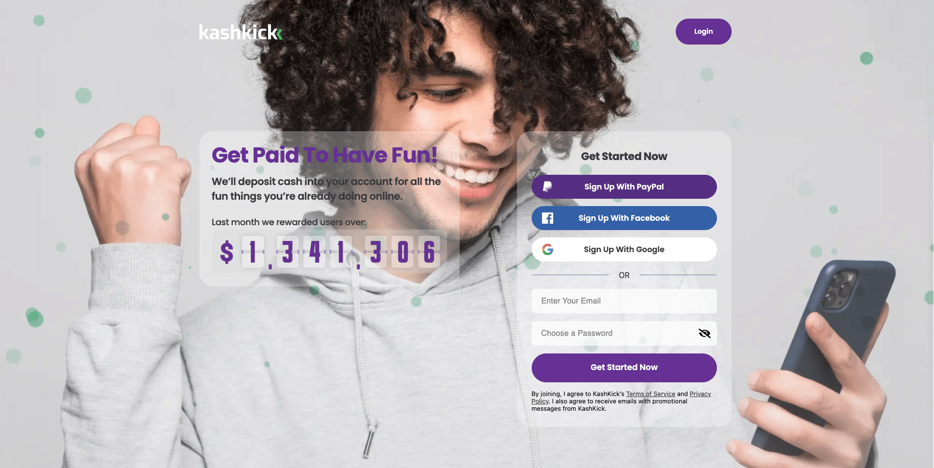 Young man celebrating while holding a phone, shown on KashKick’s registration page with options to sign up via PayPal, Facebook, or Google.